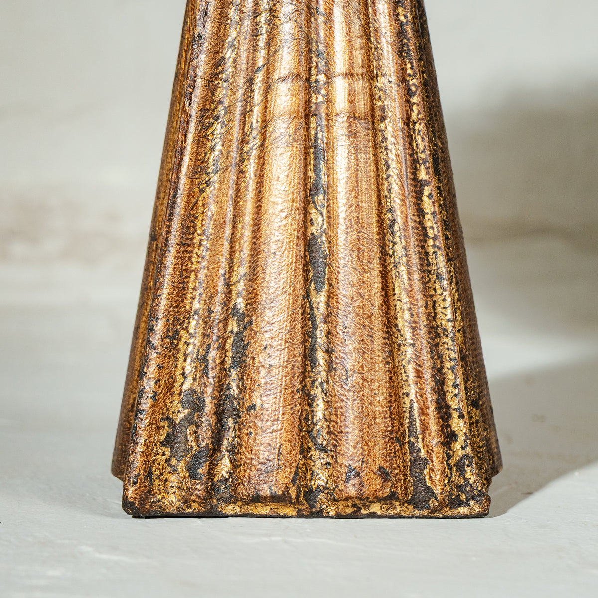 Antique gold and red wooden cake stand with flower-shaped top and tall pedestal