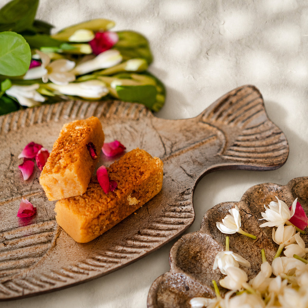 Matsya fish-shaped wooden serving platters styled with snacks and flowers