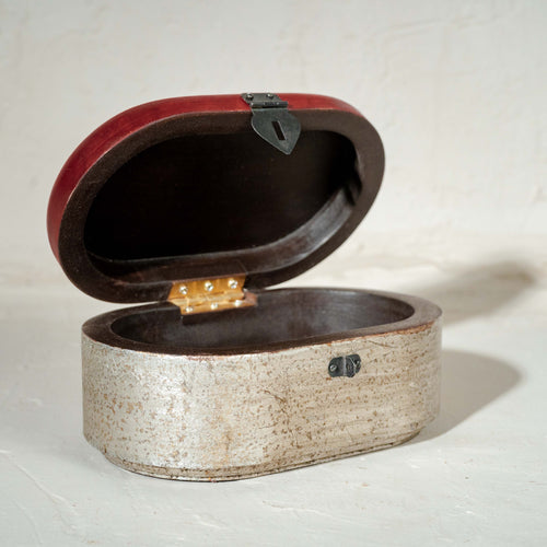 Warm-silver and red oval wooden jewellery box with an open lid