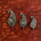 Three Kairi paisley-shaped wooden wall decorations displayed together
