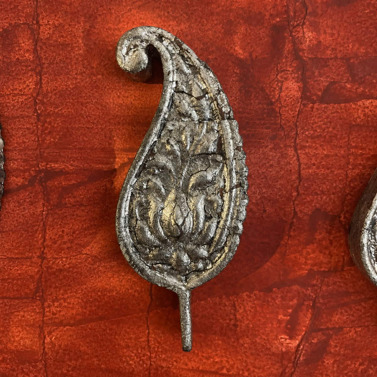 Close-up of one Kairi paisley-shaped wooden wall decoration