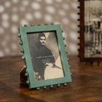 Aqua green beaded wooden tabletop photo frame holding a 5 by 7 inch photograph