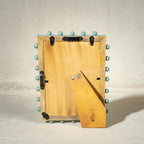 Aqua green beaded wooden tabletop photo frame holding a 5 by 7 inch photograph
