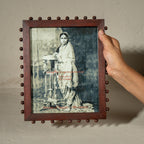 Burgundy beaded wooden tabletop photo frame holding an 8 by 10 inch photograph