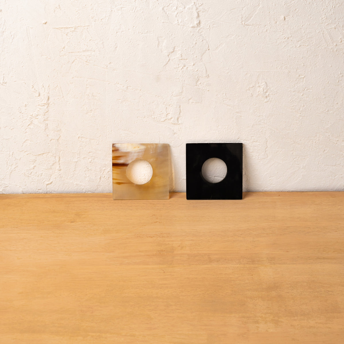 Black and translucent Block horn napkin rings displayed upright