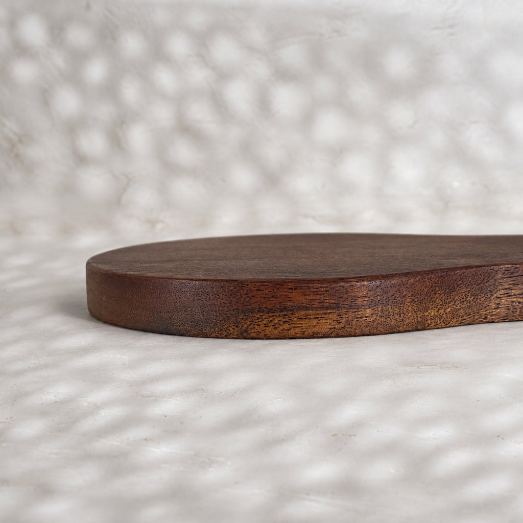 Close-up side view of the Orchard pear-shaped wooden trivet