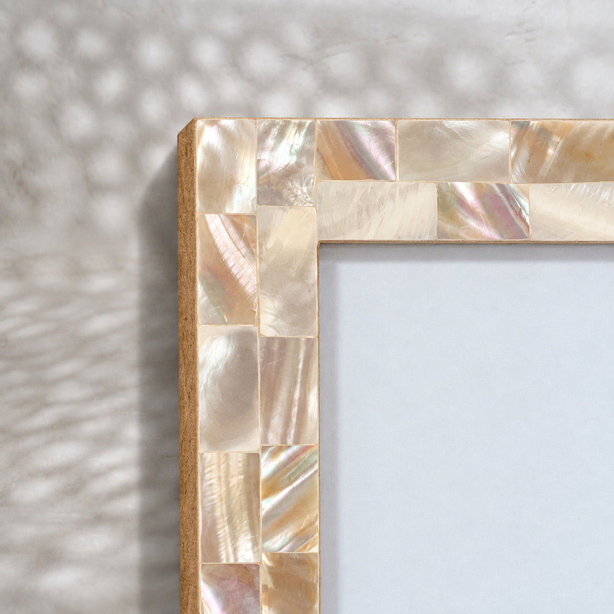 Close-up of the tiled mother-of-pearl surface on the Champagne photo frame