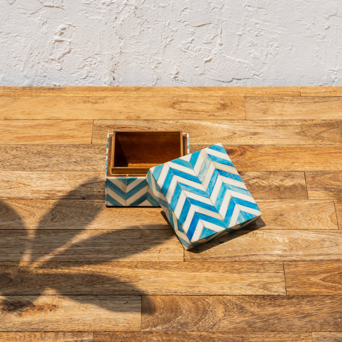 Angled view of the open Chevron wooden storage box and lid
