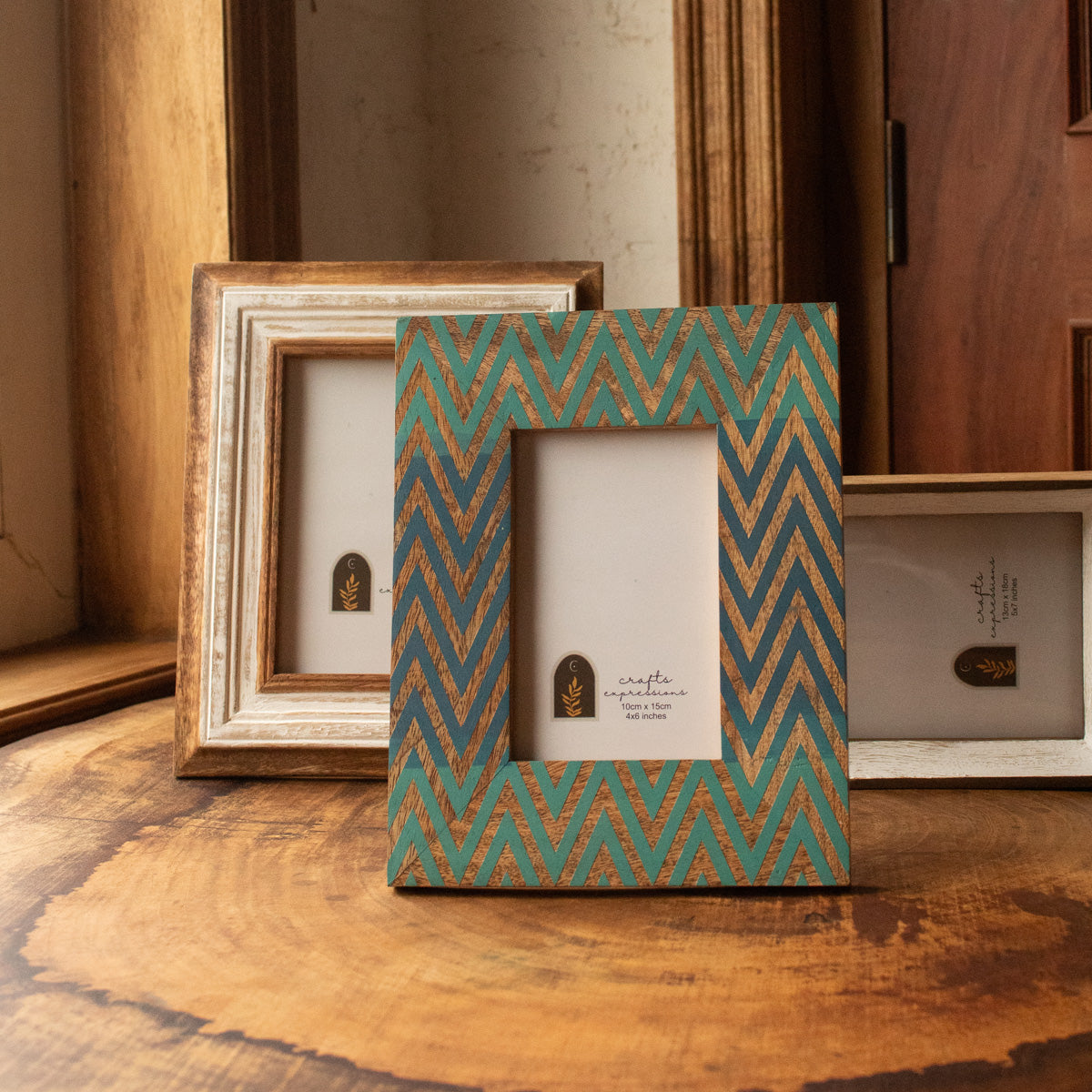 Chevron wooden photo frame displayed vertically with other frames