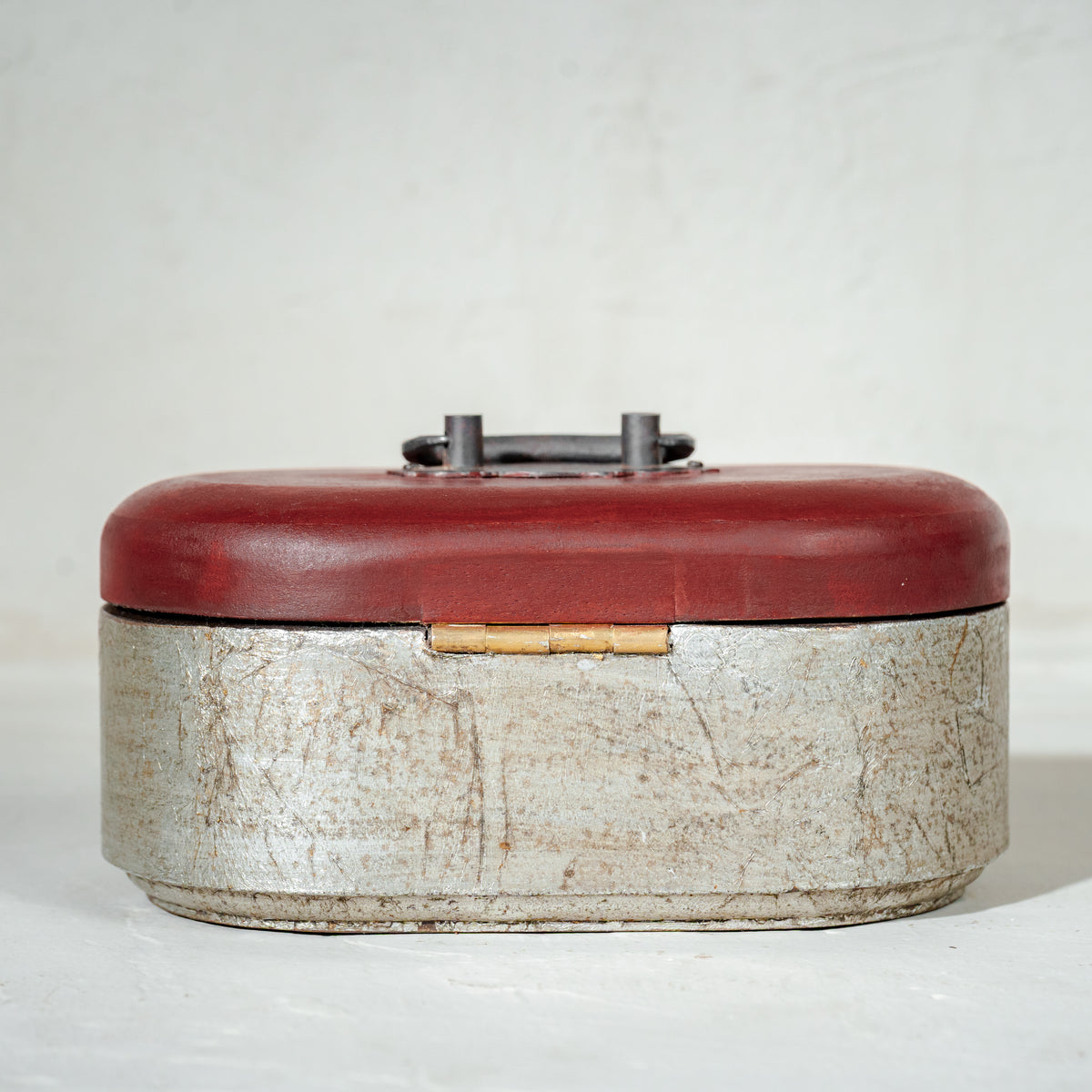 Warm-silver and red oval wooden jewellery box with an open lid