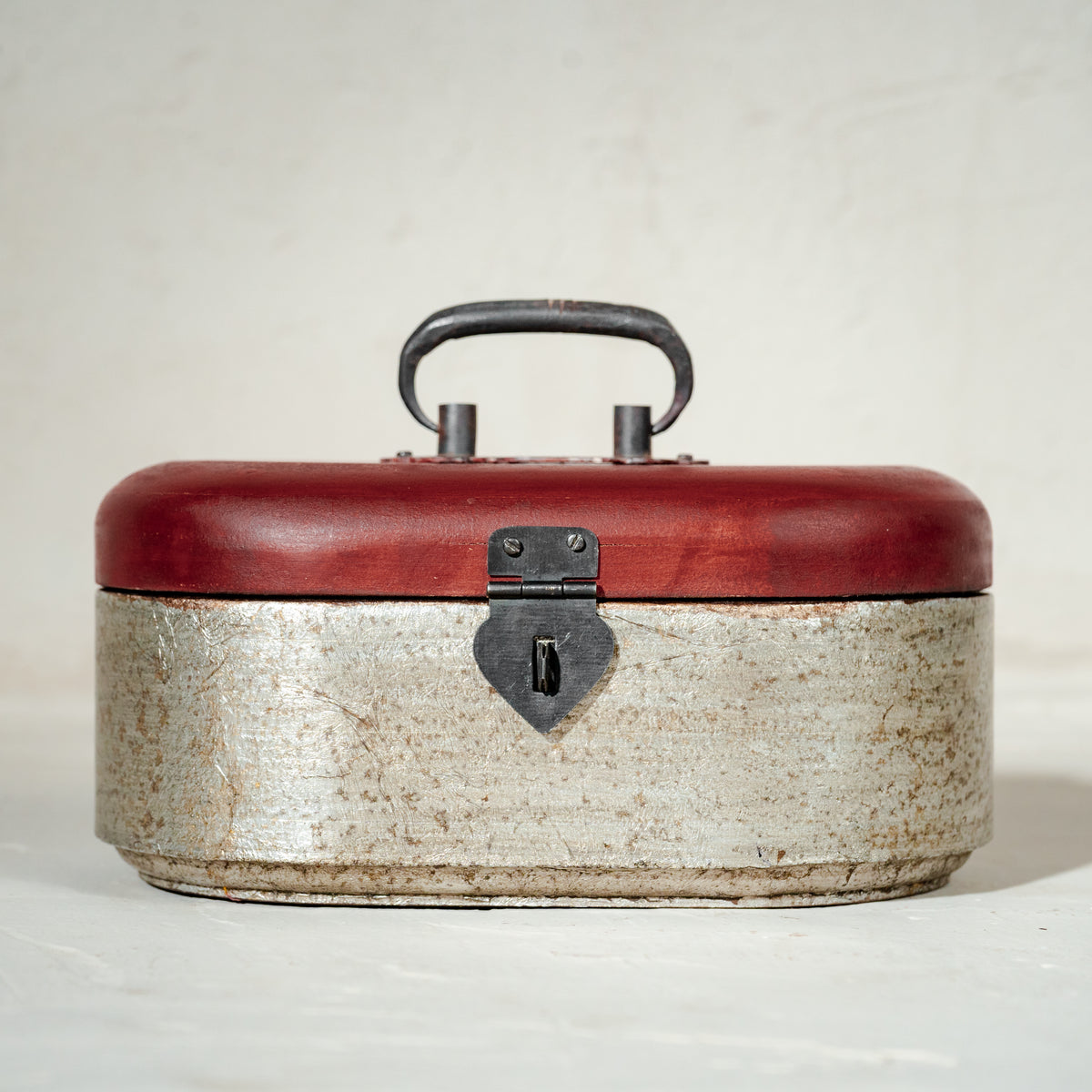 Warm-silver and red oval wooden jewellery box with an open lid
