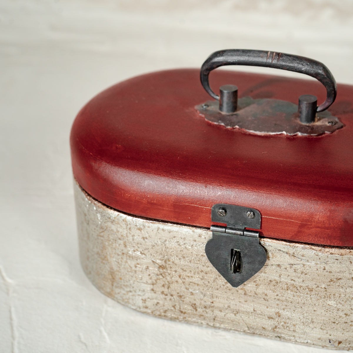 Warm-silver and red oval wooden jewellery box with an open lid