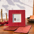 Warm red Dottie square photo frame styled with brass décor