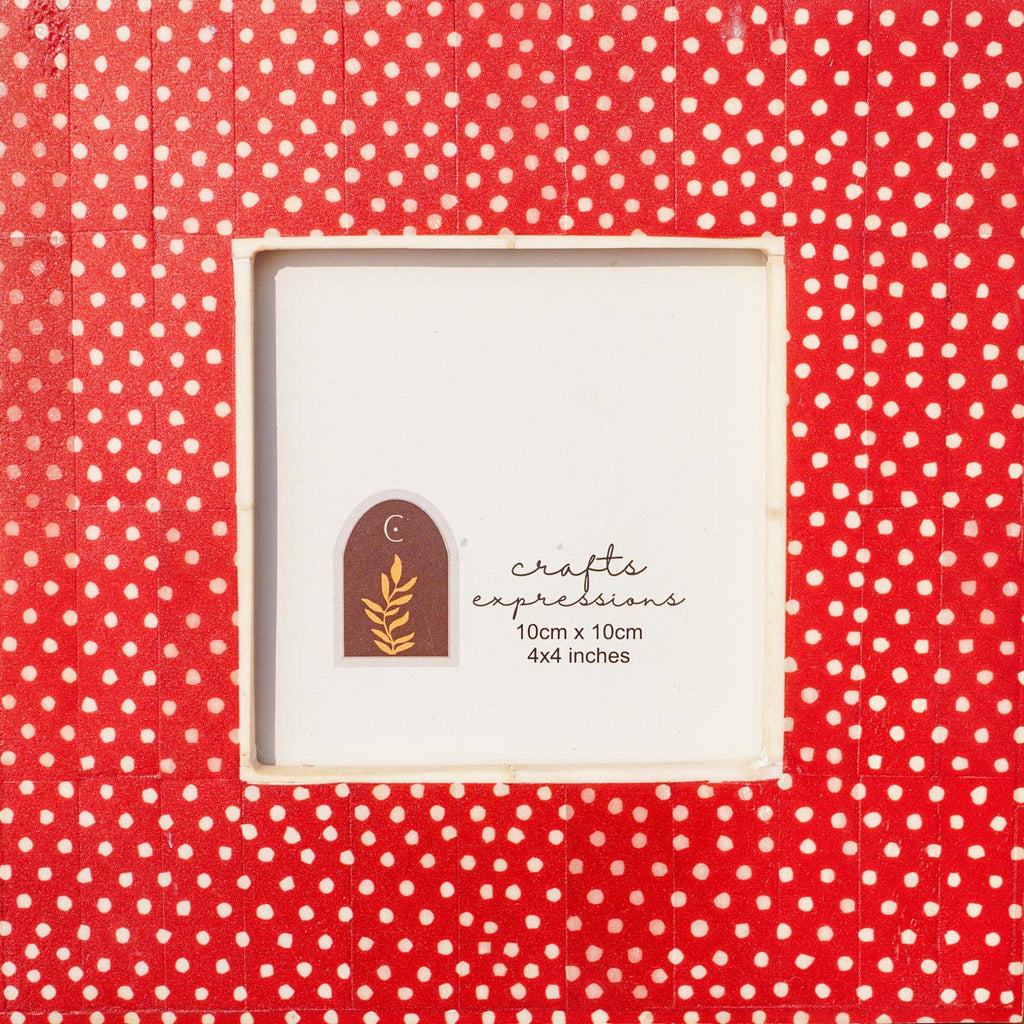 Close-up of the white dotted pattern on the warm red Dottie photo frame