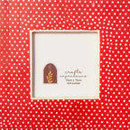 Close-up of the white dotted pattern on the warm red Dottie photo frame