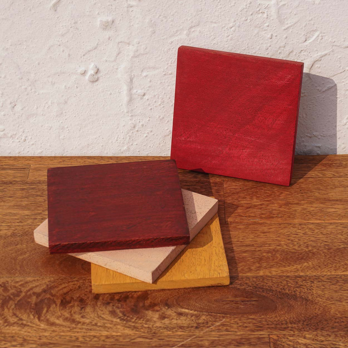 Earth Block wooden coaster set stacked and spread on a table