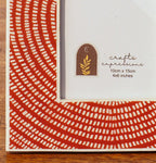Close-up of the red circular pattern on the Echo wooden photo frame