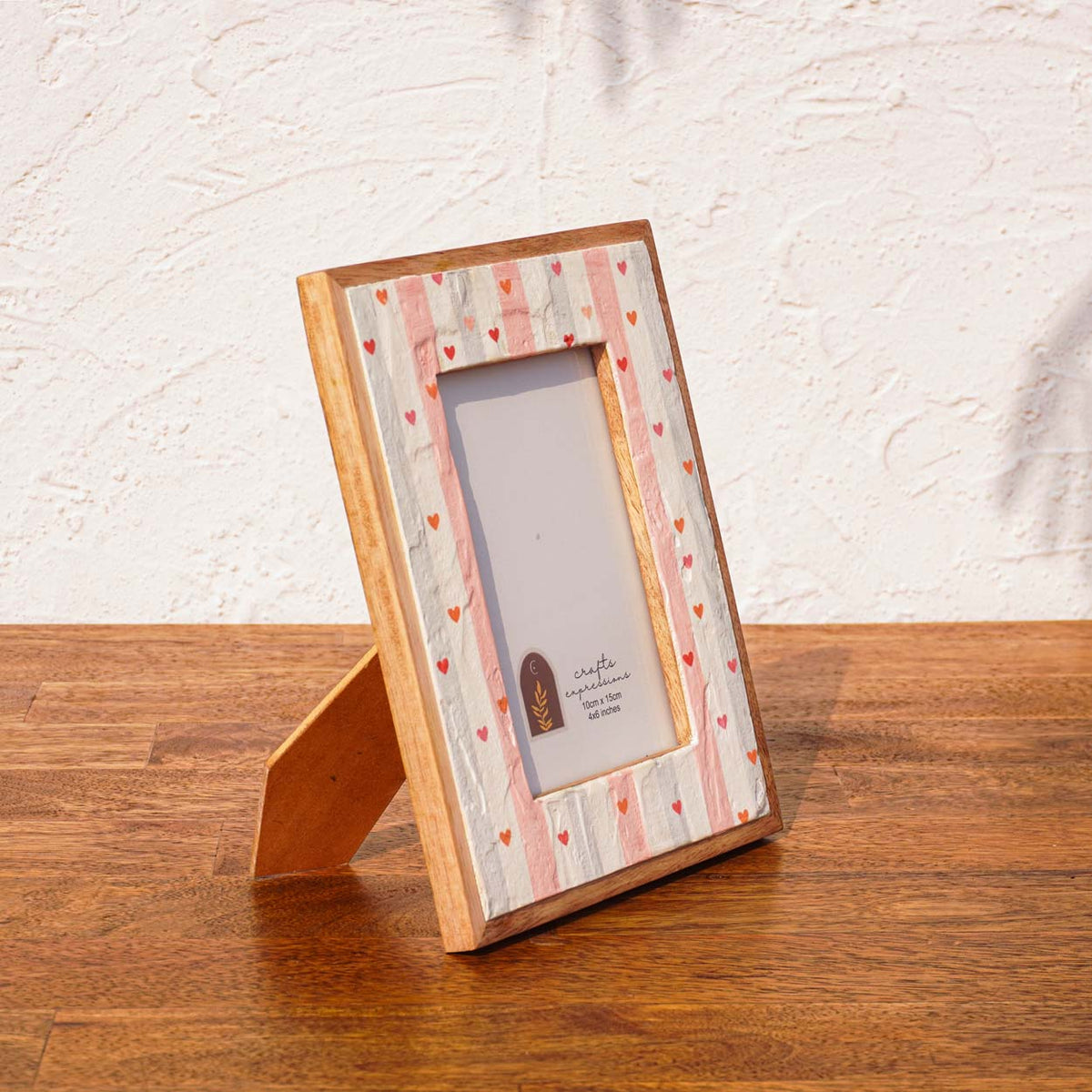 Angled view of the Little Hearts wooden photo frame with easel stand