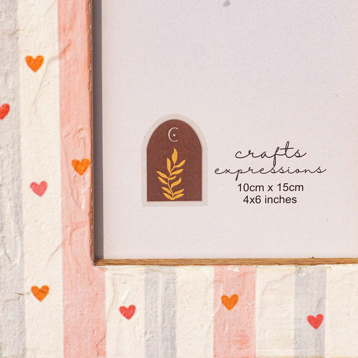 Close-up of the painted stripes and heart details on the Little Hearts frame