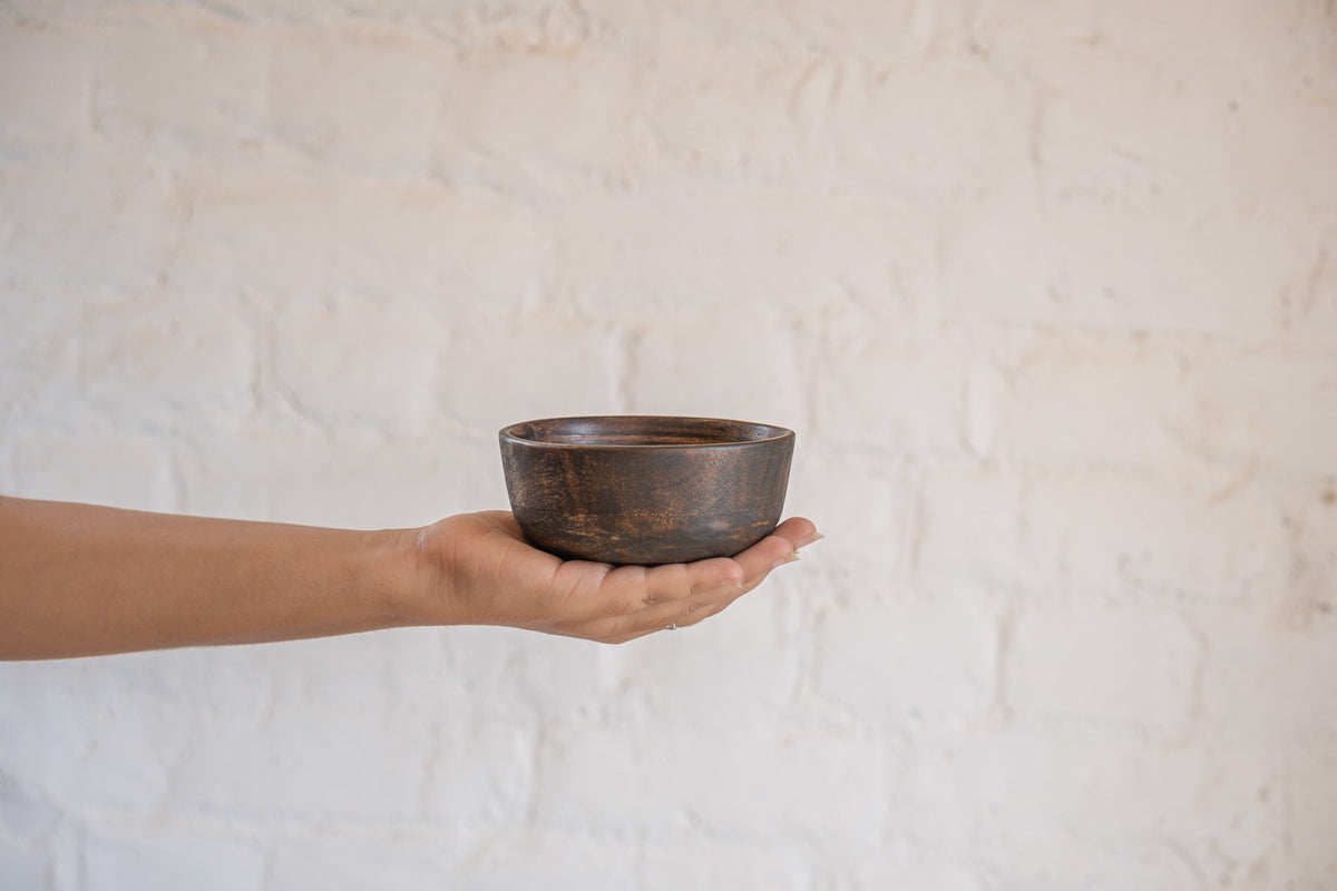 Orbit wooden nut bowl held in one hand
