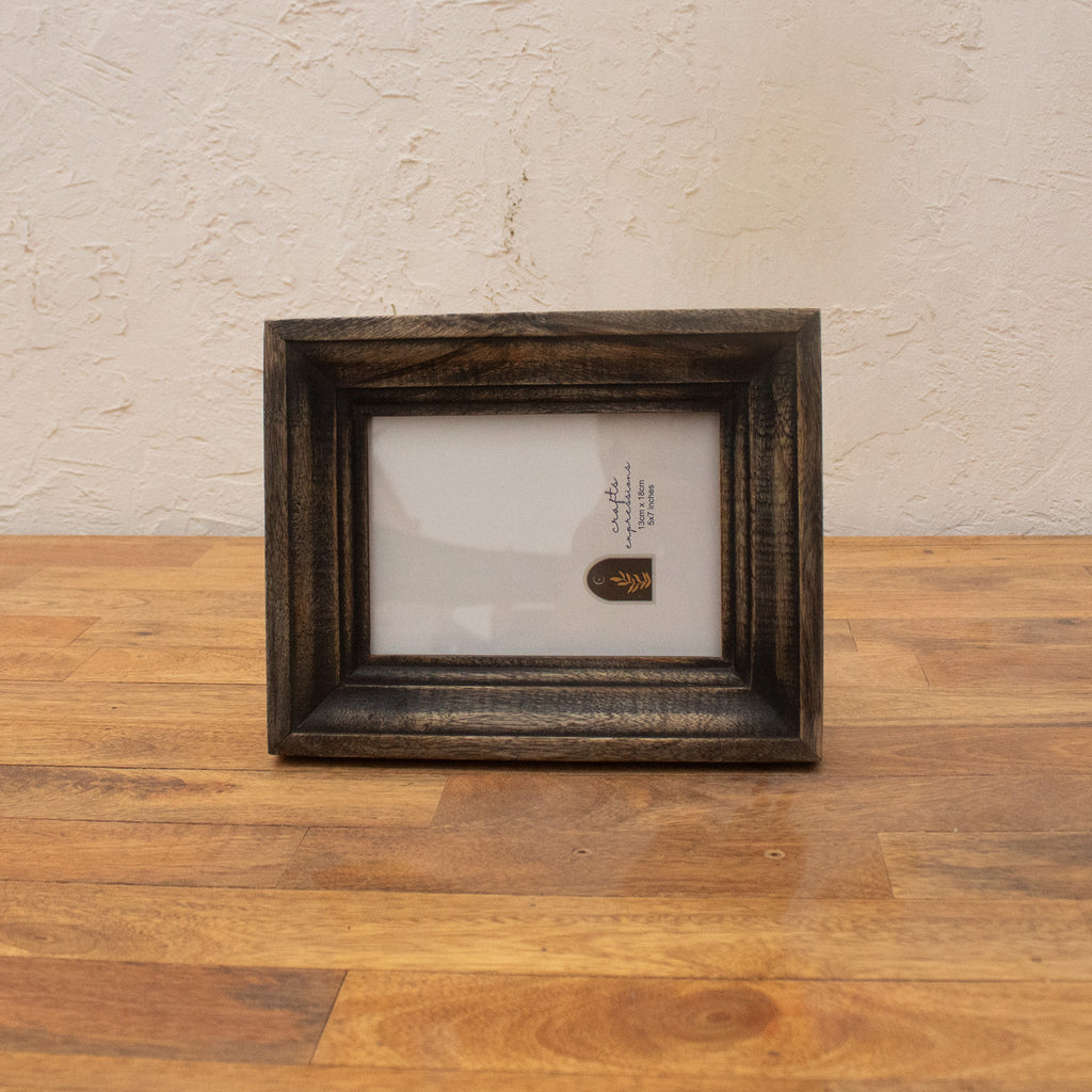 Dark wooden photo frame displayed horizontally
