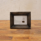 Dark wooden photo frame displayed horizontally