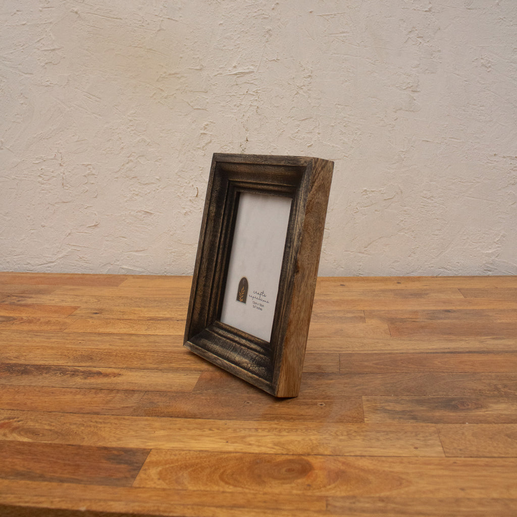 Side view of the dark wooden photo frame with easel stand