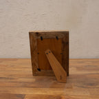 Back view of the dark wooden photo frame with easel stand and wall hooks