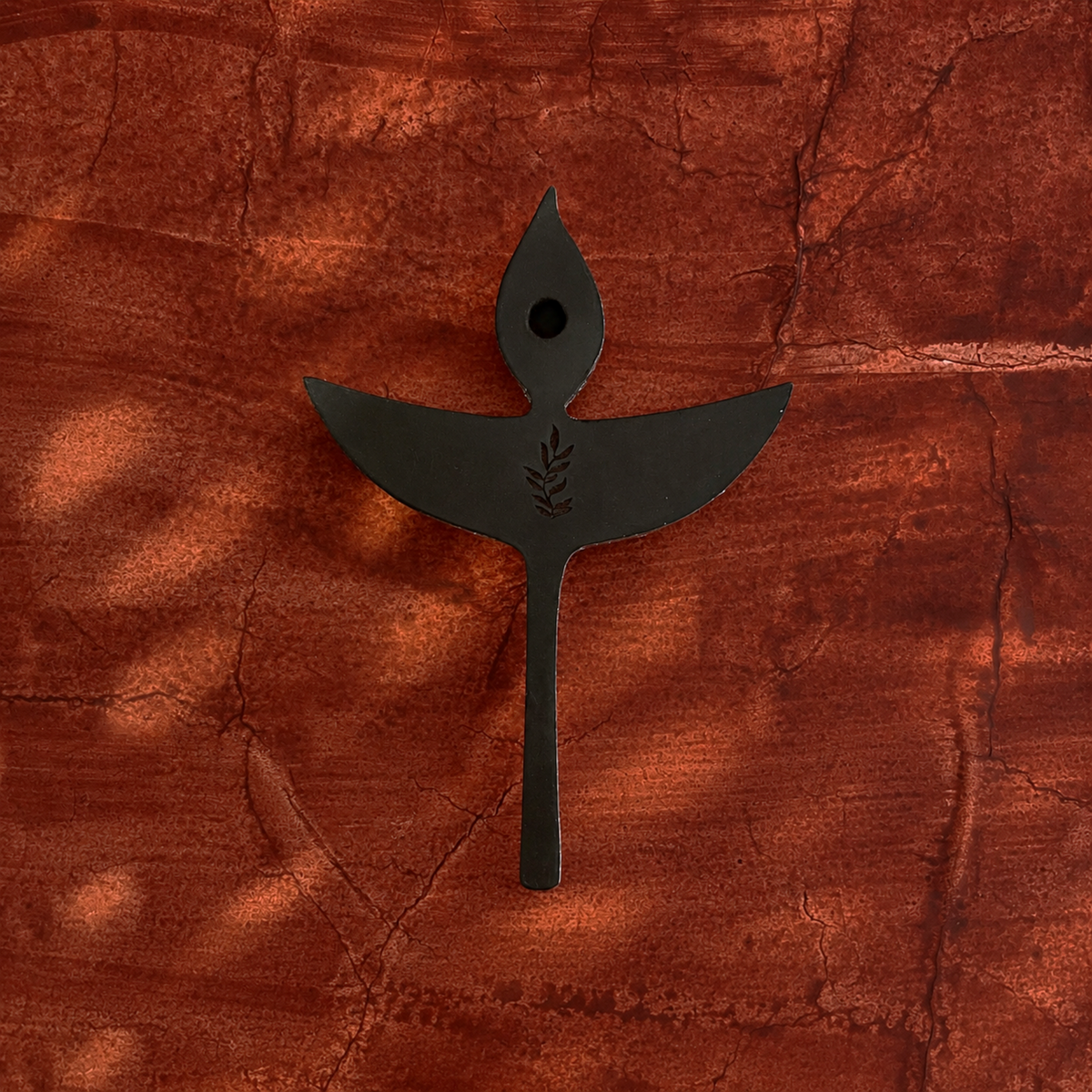 Back view of one Nuri diya-shaped wooden wall decoration