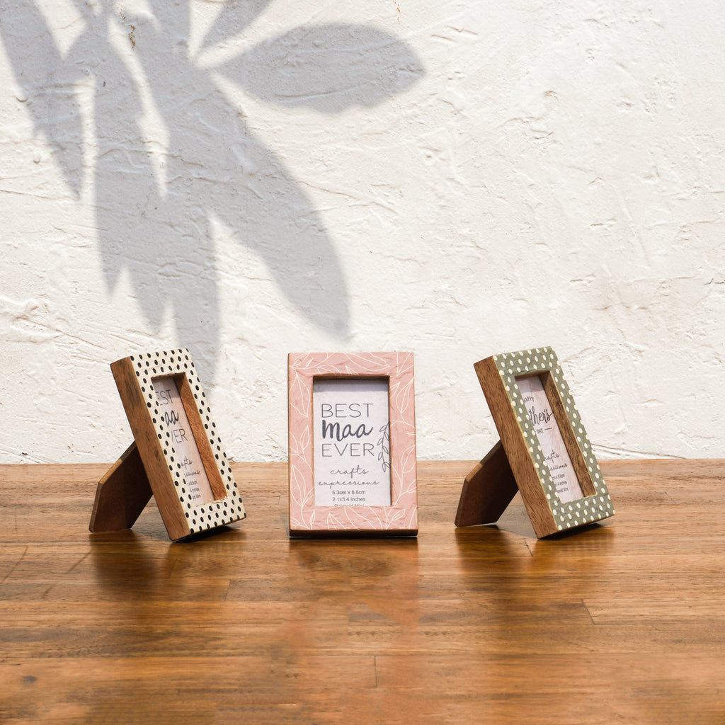 Angled views of three Dots & Petals wooden Instax Mini frames