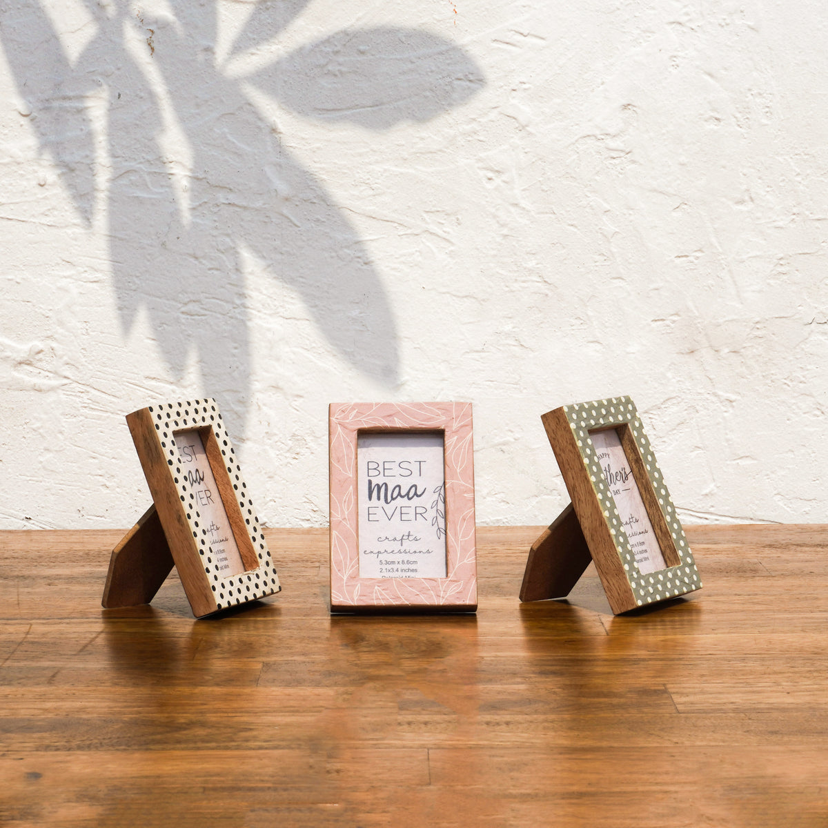 Angled views of three Dots & Petals wooden Instax Mini frames