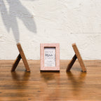 Side and front views of Dots & Petals wooden Instax Mini frames with easel stands