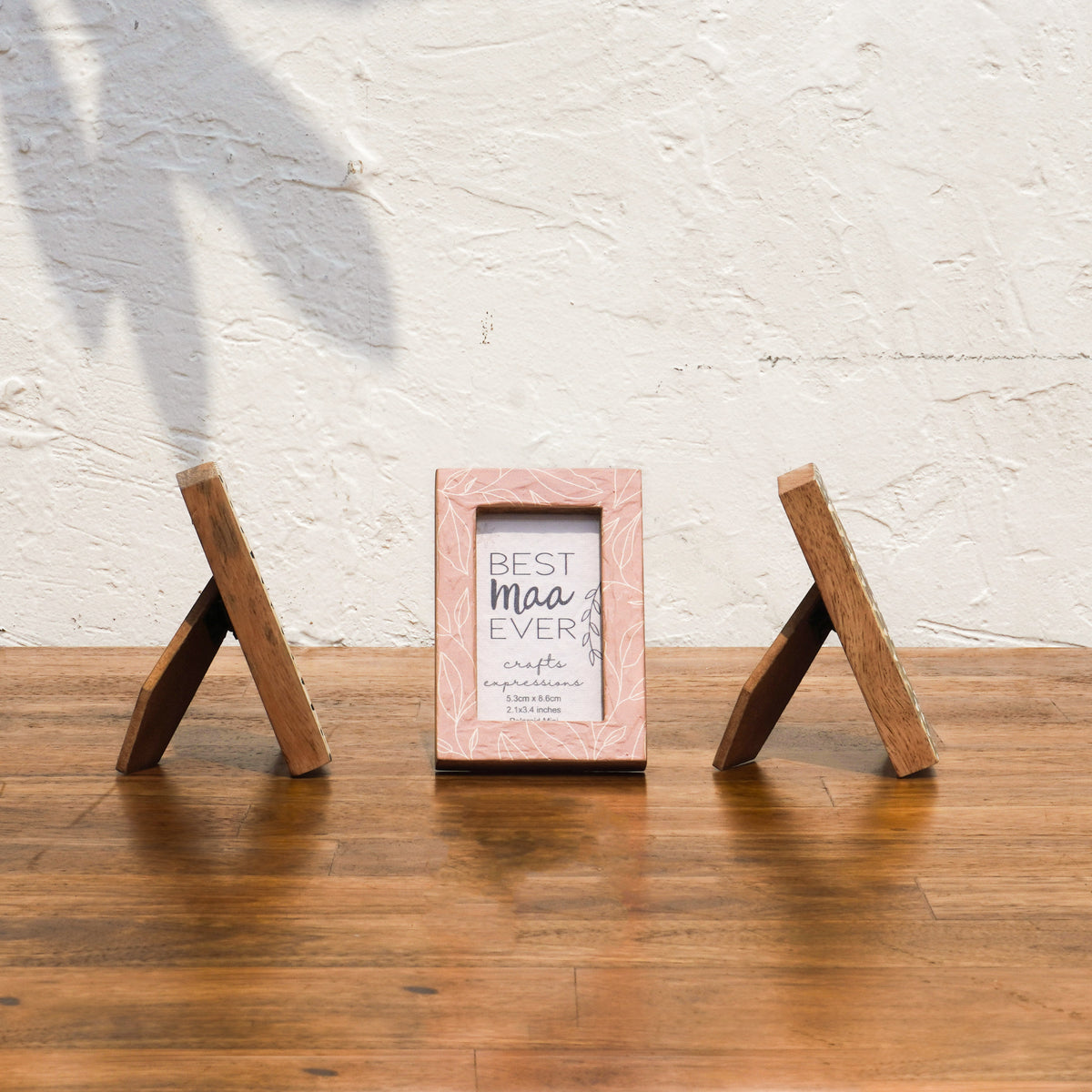 Side and front views of Dots & Petals wooden Instax Mini frames with easel stands