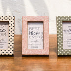 Close-up of Dots & Petals wooden Instax Mini frames in white, pink and olive