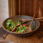 Ellipse large wooden serving bowl filled with salad and wooden servers