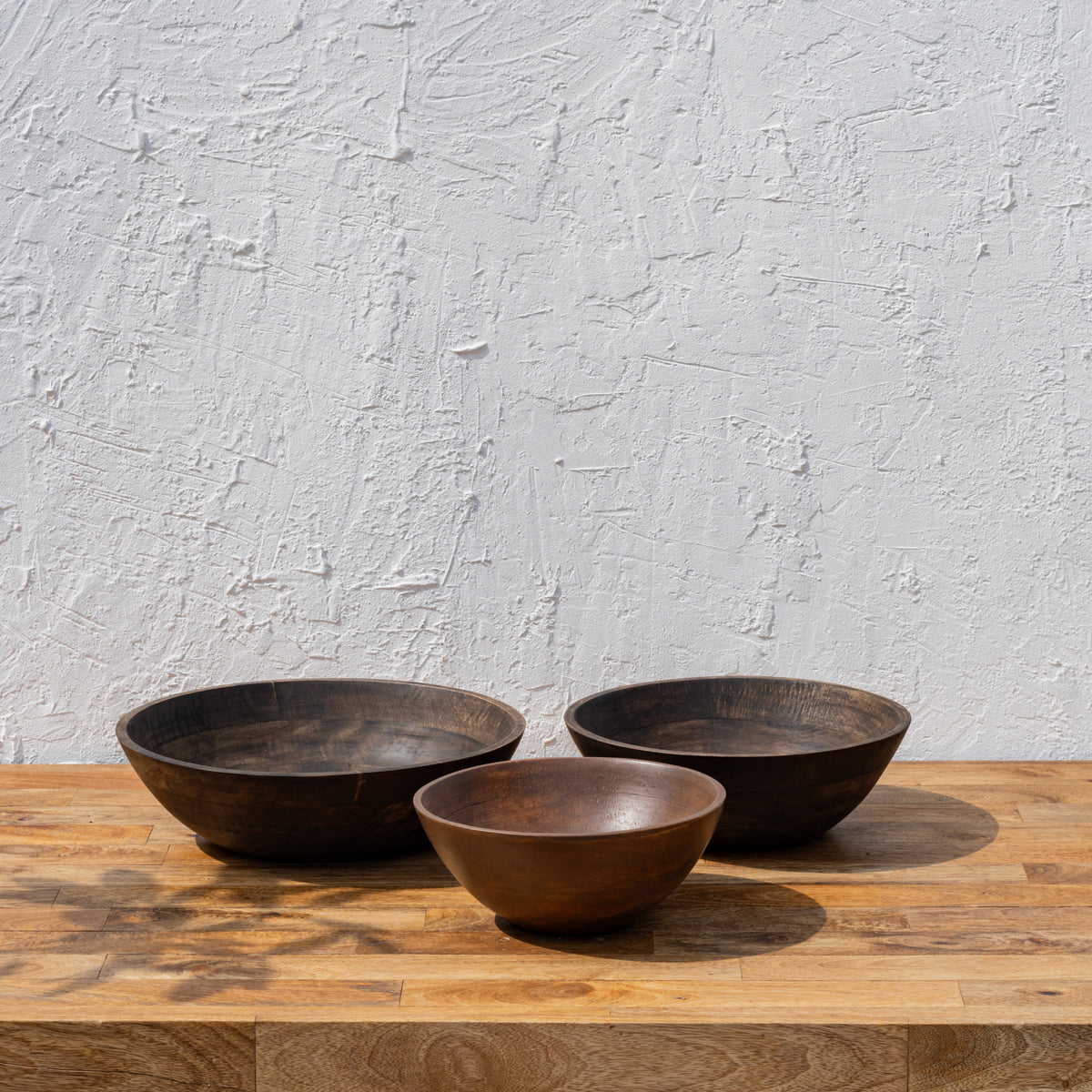 Three Ellipse wooden serving bowls arranged together