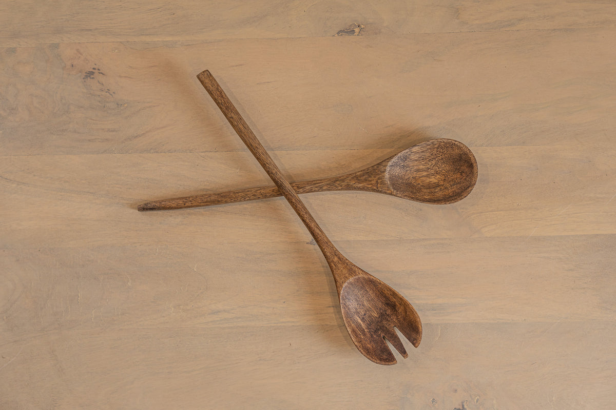 Pair of Ellipse wooden salad servers crossed on a tabletop