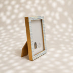 Warm-white wooden photo frame with fine blue-grey stripes for a 4 by 6 inch photograph