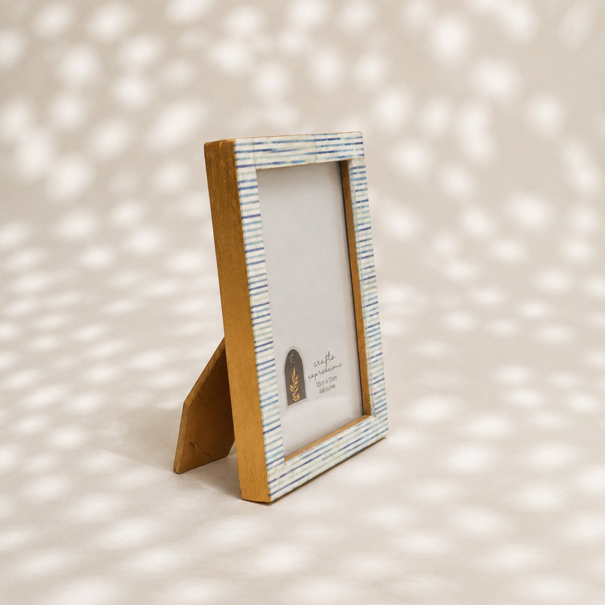 Warm-white wooden photo frame with fine blue-grey stripes for a 4 by 6 inch photograph