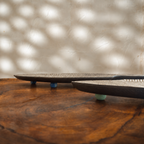 Low side view of the two Matsya fish-shaped wooden serving platters