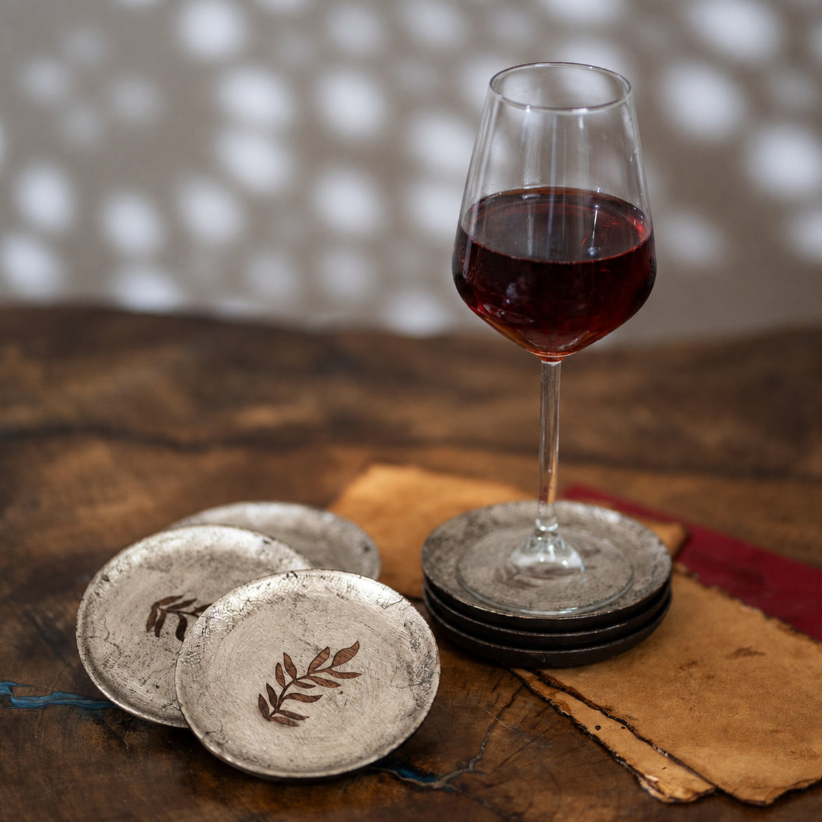 Set of six round wooden coasters with distressed finish and rust botanical motifs