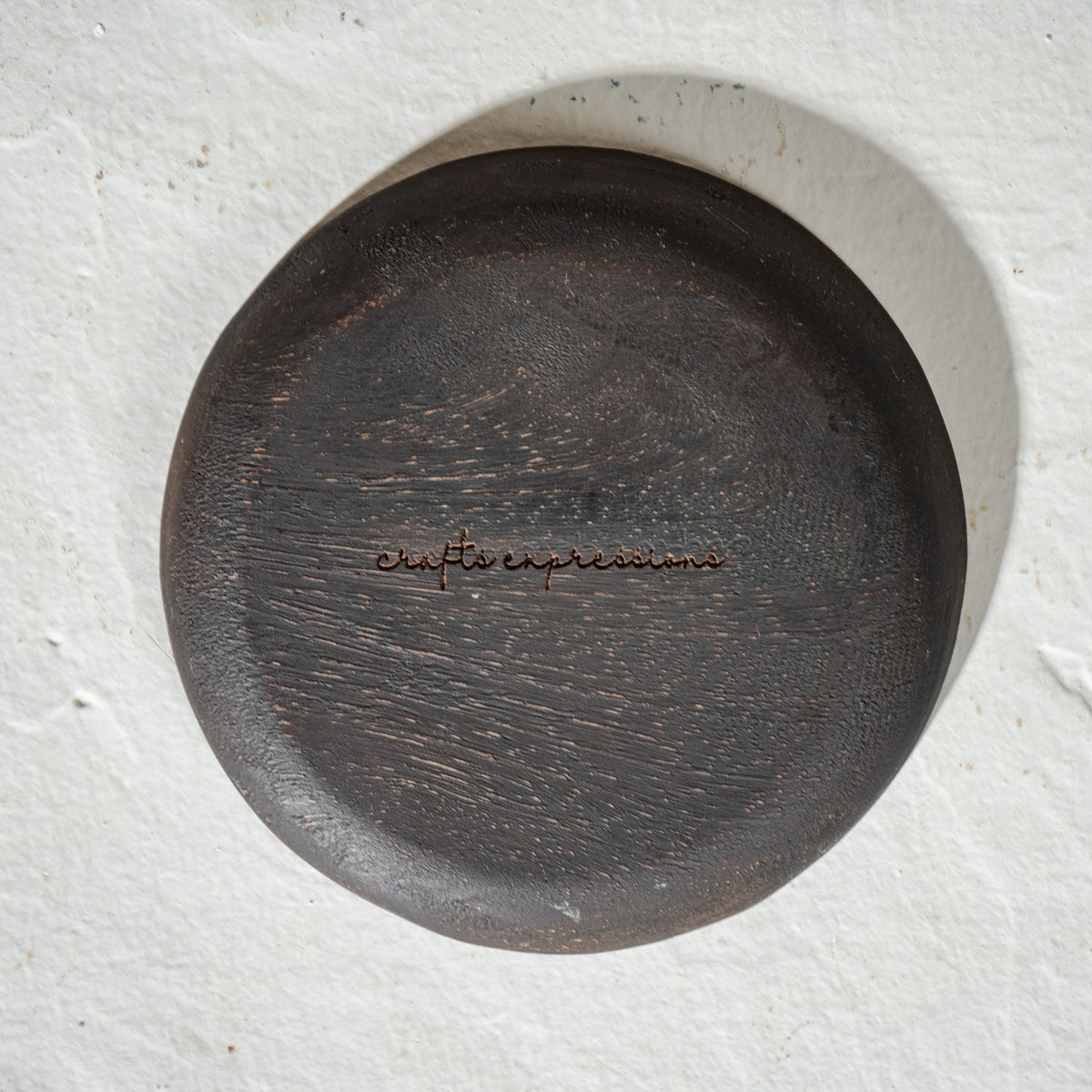 Set of six round wooden coasters with distressed finish and rust botanical motifs