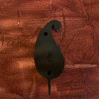 Back view of one Kairi paisley-shaped wooden wall decoration