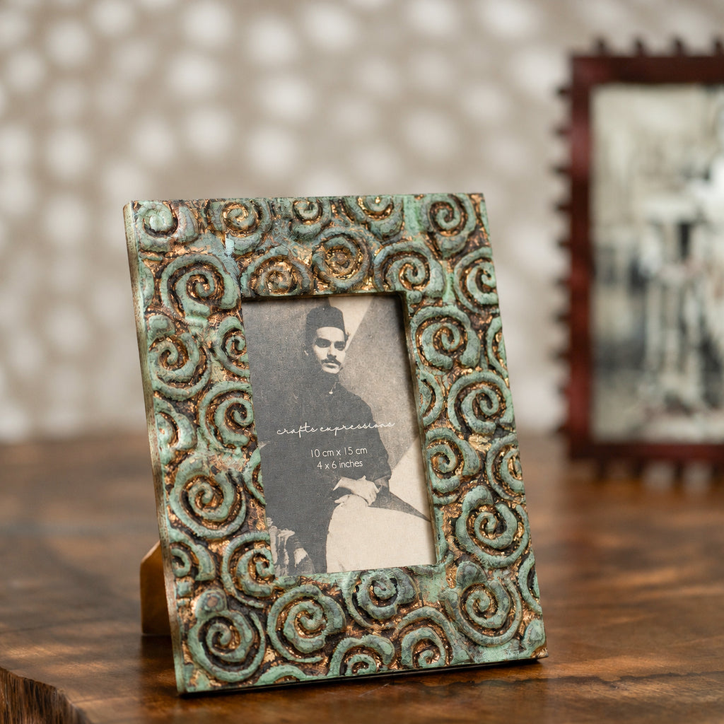 Carved gold-green wooden photo frame holding a 4 by 6 inch photograph