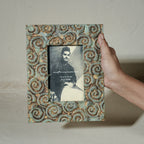 Carved gold-green wooden photo frame holding a 4 by 6 inch photograph