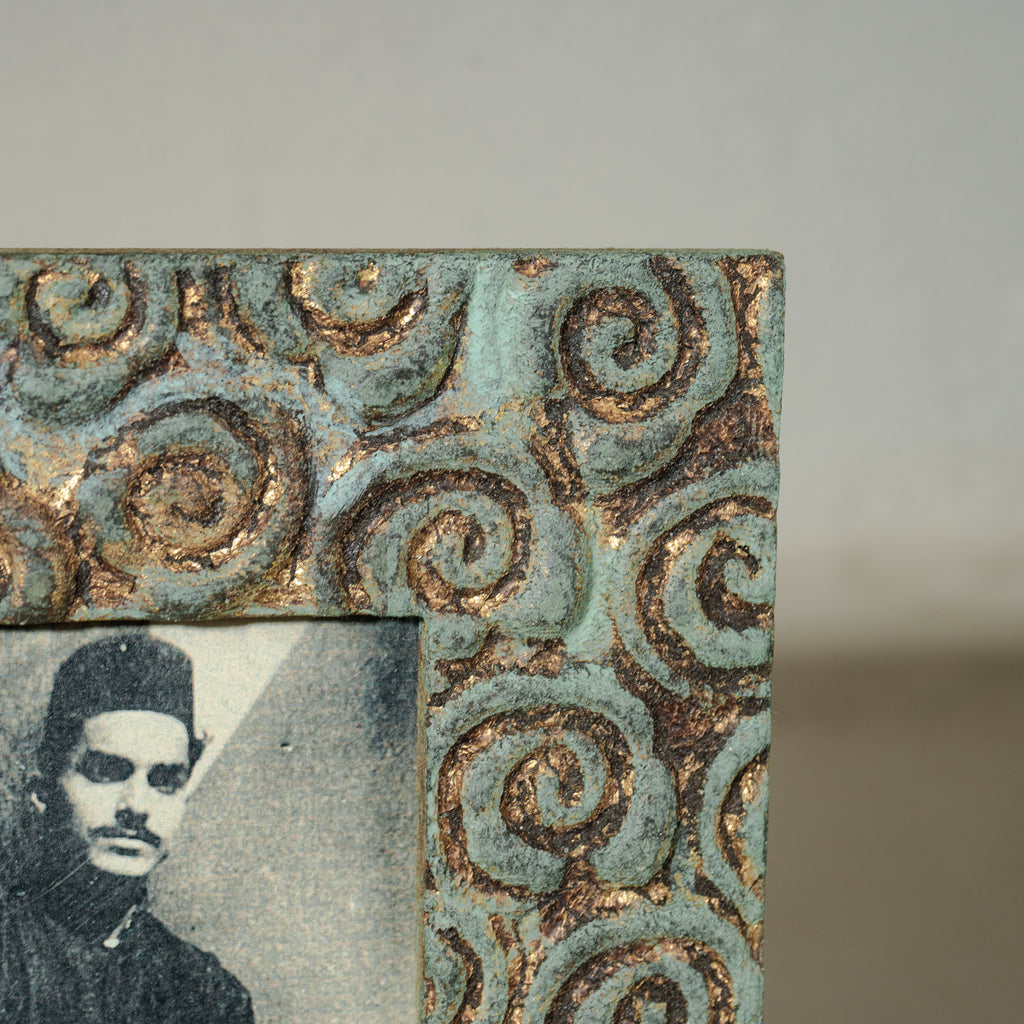 Carved gold-green wooden photo frame holding a 4 by 6 inch photograph