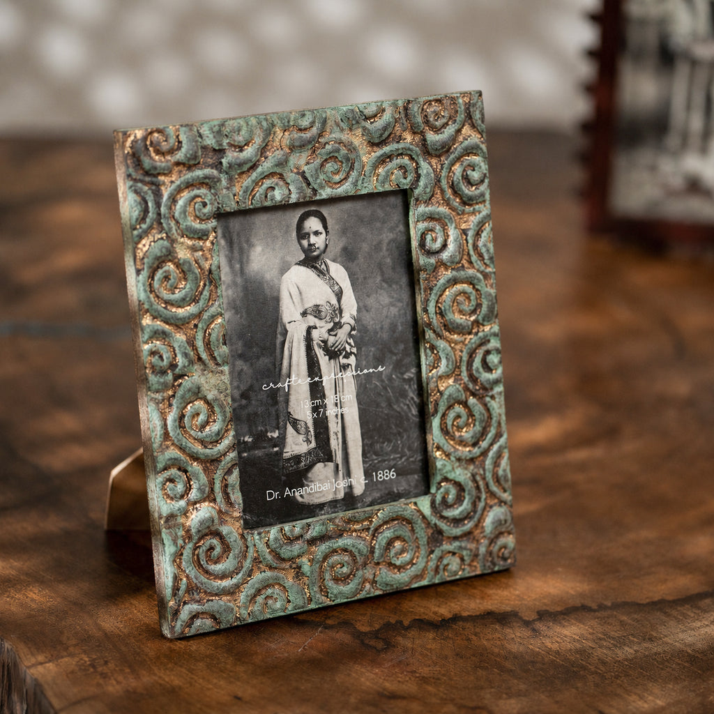 Carved gold-green wooden photo frame holding a 5 by 7 inch photograph