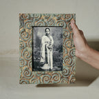 Carved gold-green wooden photo frame holding a 5 by 7 inch photograph