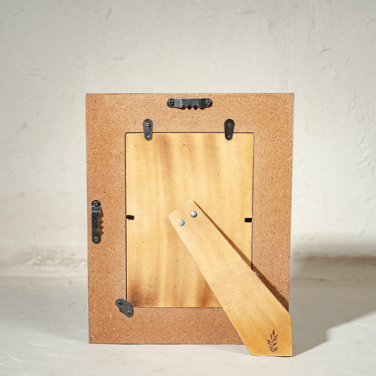 Carved gold-green wooden photo frame holding a 5 by 7 inch photograph