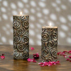 Set of two tall antique carved wooden tea light holders in different heights